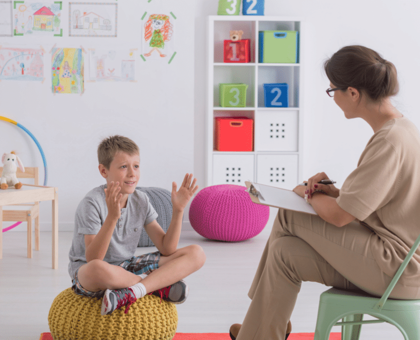 boy clapping with therapist