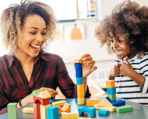 woman and child playing with blocks