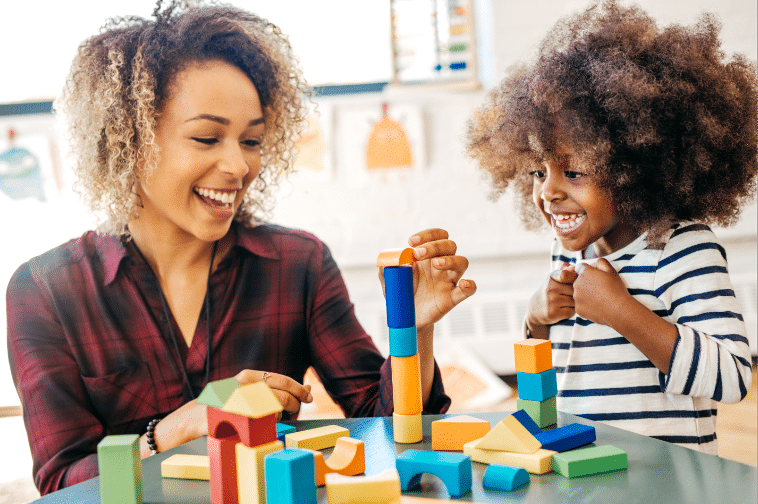 woman and child playing with blocks