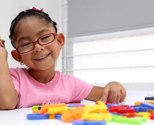 little girl with colorful blocks