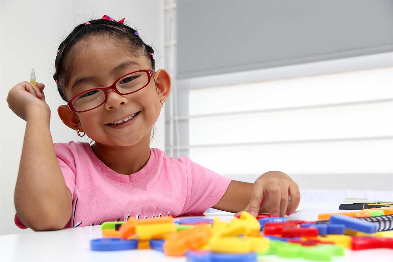 little girl with colorful blocks