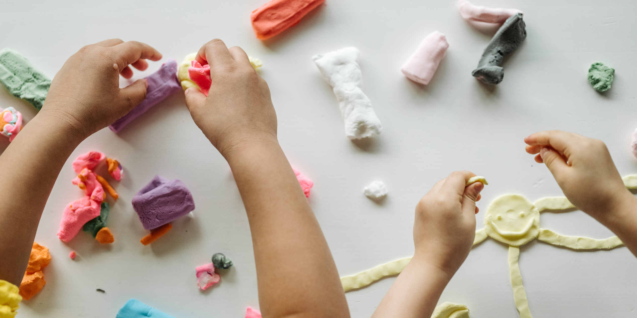 Children hands playing with clay 