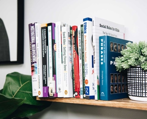 Books on bookshelf with plants