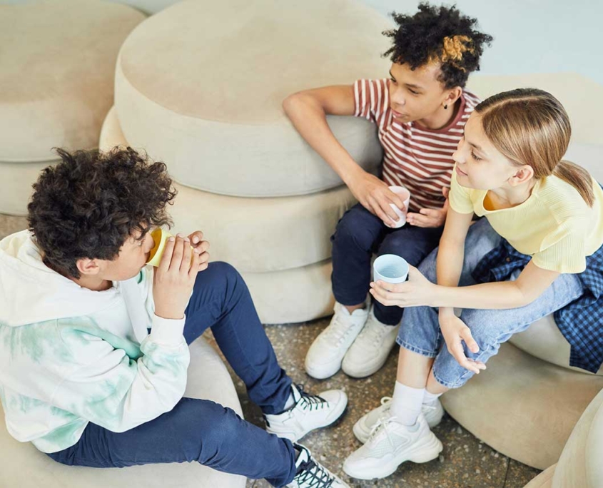 group of three kids sitting together