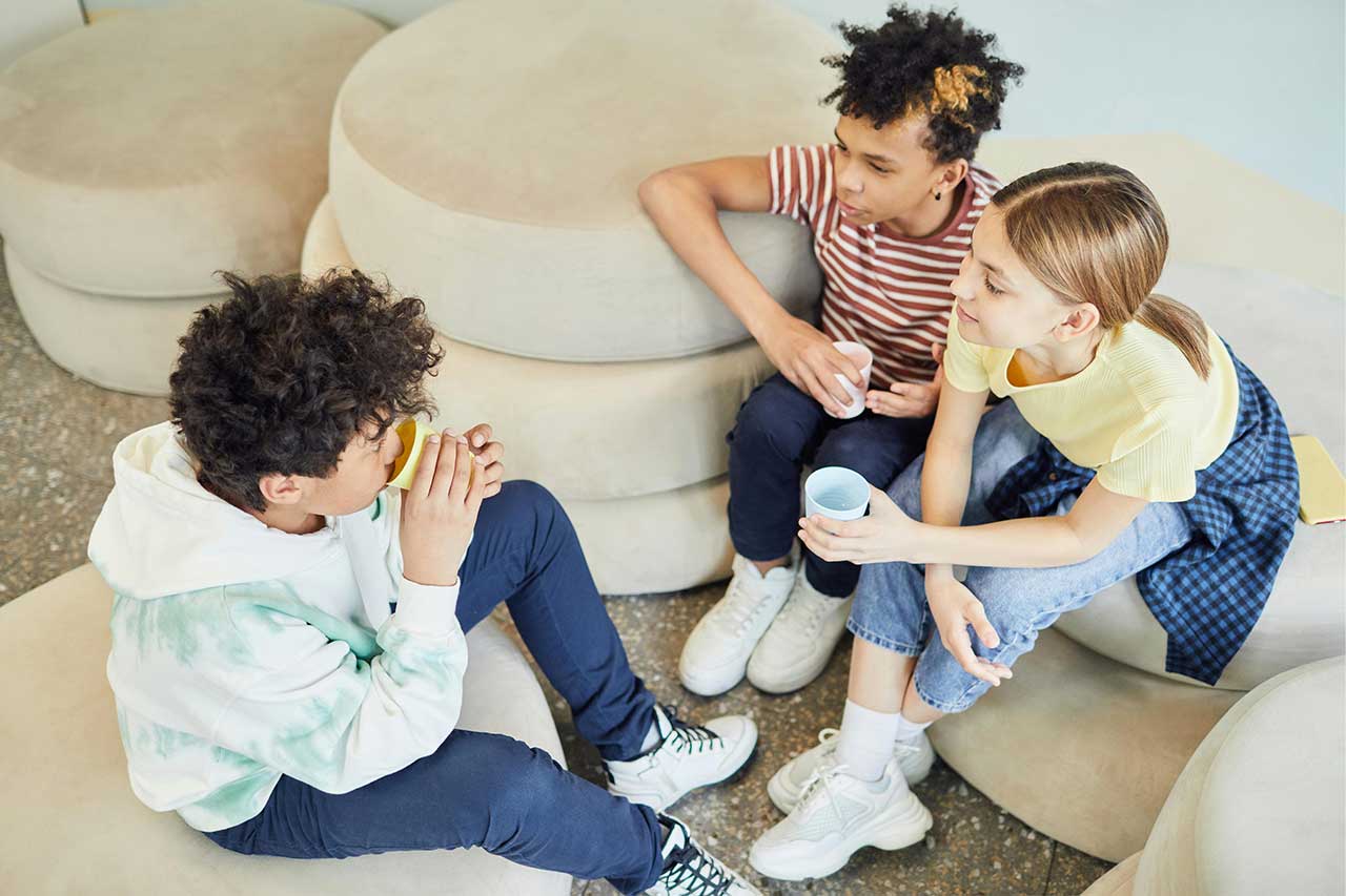 group of three kids sitting together