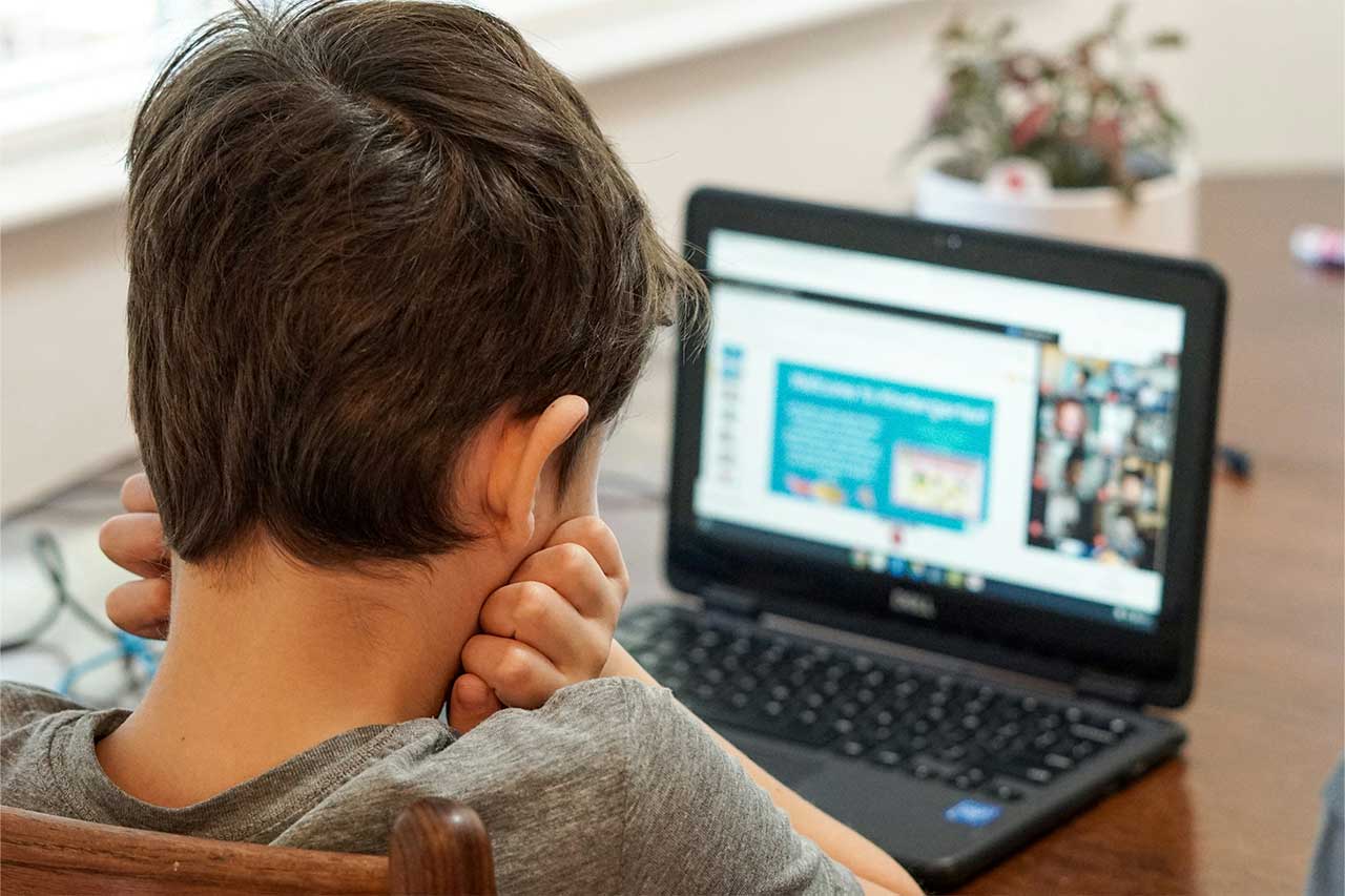 male child on a computer